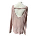 the delicate open-knit stitching and soft pink cotton-blend fabric on an American Eagle sweater.